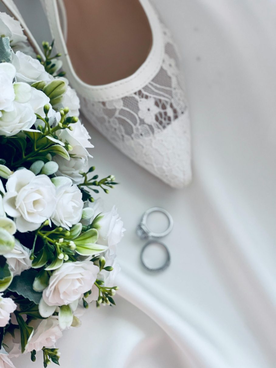 Wedding shoes and rings styled with flowers